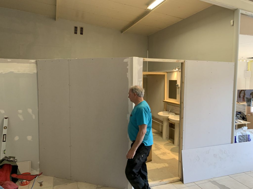 Tony, master carpenter and volunteer completing dry wall for the bathrooms, showers and toilets for the Actions Beyond Words base in Medyka, Poland
