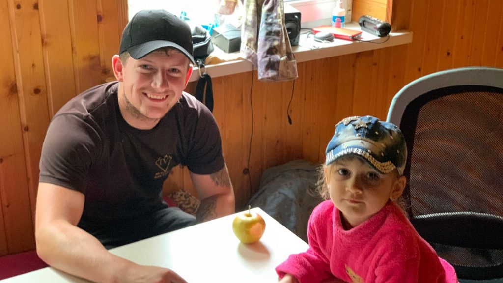 Picture of Nathan Mullaney, working with Actions Beyond Words (ABW) with a Ukrainian little girl in Irpin after an invite to have lunch with the family