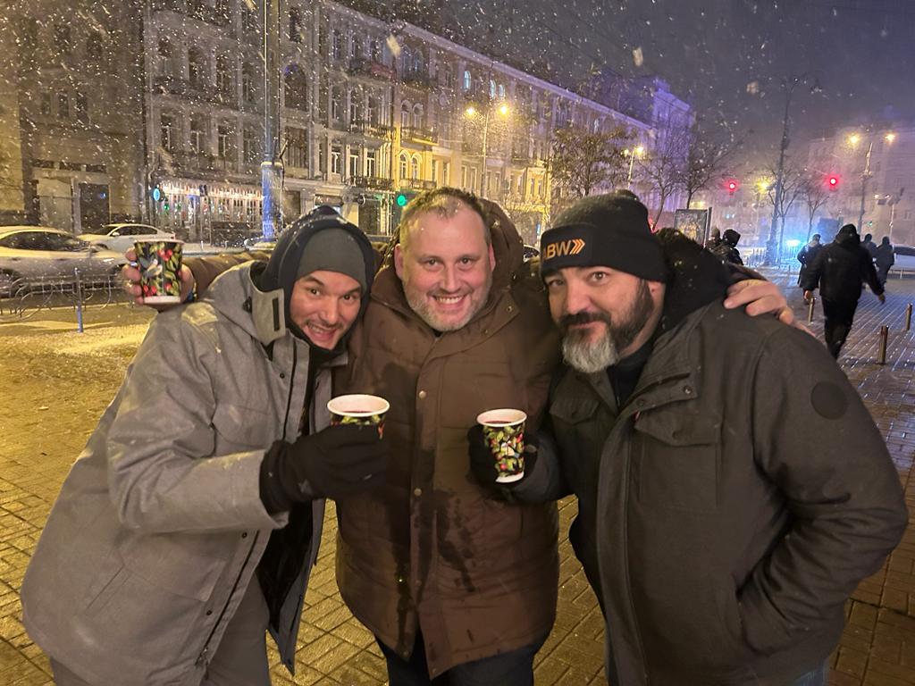 Flavio, Simon, and Travis enjoy a warm local specialty on a cold Kyiv evening.