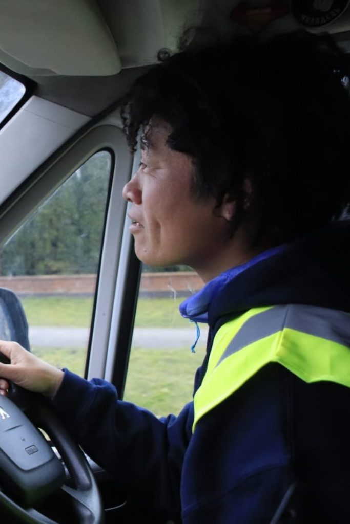 Abe-Chan at the wheel of the ABW van looking focused on the road ahead