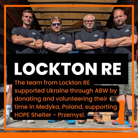 Picture of the team from Lockton RE on the back of a truck after unloading at Actions Beyond Words Medyka Warehouse